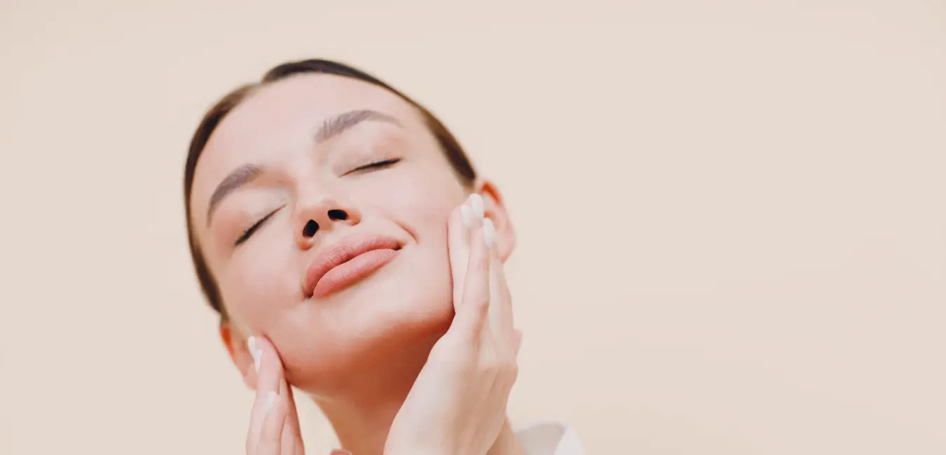 Woman misting face with natural Moroccan rose water